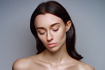 Portrait of a Natural Woman with Clean Skin on a Minimal Background