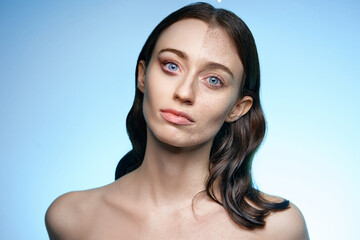 An artistic photo showcasing a woman with a split facial appearance illustrating skin differences...