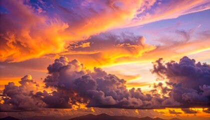 A vibrant sunset sky with dramatic orange, purple, and pink clouds over a distant mountain range.
