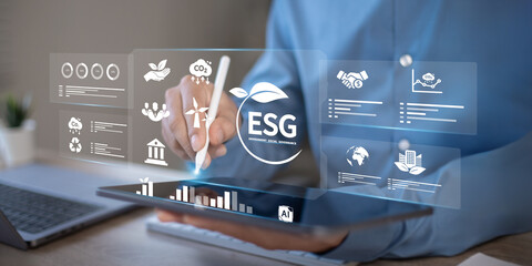 Businessman pressing button on tablet screen with ESG for Environment, Social and Governance in sustainable and ethical business operations.