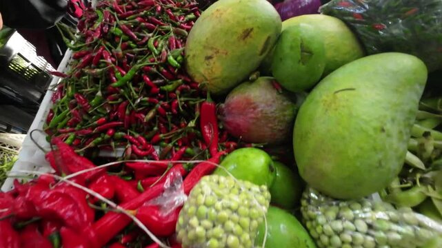 Overhead pan showing vibrant fruits and vegetables at Quinta Crespo food market in Caracas, Venezuela.