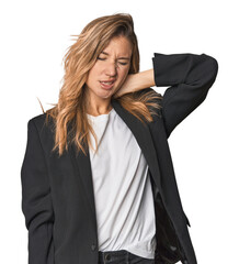 Young businesswoman in a suit suffering neck pain due to sedentary lifestyle.