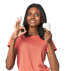 Young Indian woman with facial cleanser cheerful and confident showing ok gesture.