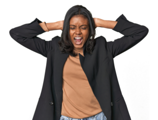 Young Indian woman in business suit covering ears with hands trying not to hear too loud sound.