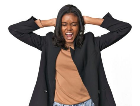 Young Indian woman in business suit covering ears with hands trying not to hear too loud sound.