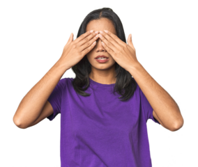 Young Latina posing in studio afraid covering eyes with hands.