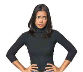 Simple portrait of a young Latina confused, feels doubtful and unsure.