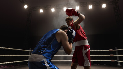 A boxing match unfolds with two fighters, one in red and the other in blue, under bright 3D arena...