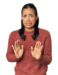 Young Filipina woman rejecting someone showing a gesture of disgust.