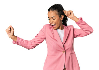 Young Filipina woman in pink suit dancing joyfully