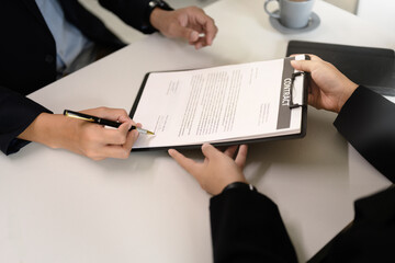 Professional agreement being signed, symbolizing partnership, commitment, or closing a deal.