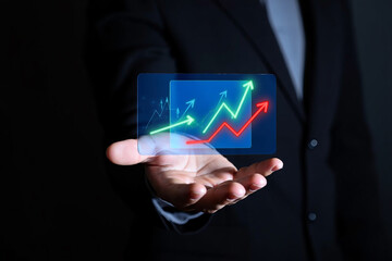 Business professional presenting upward trending financial growth charts on a holographic display