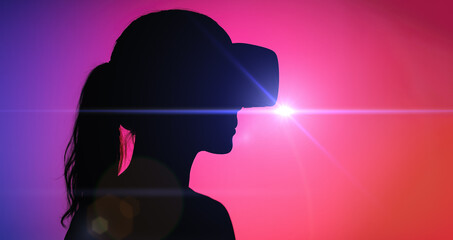 Woman silhouette with VR visor gazes into glowing pink universe. inclusive future of virtual social connection technology