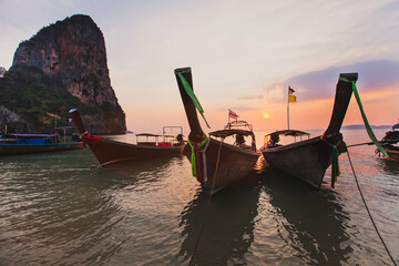 long-tail boats at sunset beach in Krabi, Thailand