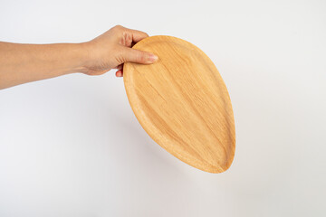 Oval wooden plate in hand on white background