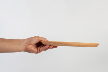 Oval wooden plate in hand on white background