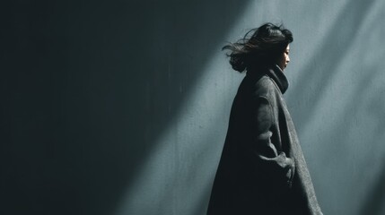 Moody portrait of a person in a coat against a dark atmospheric backdrop