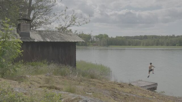 SAARISTO M&Ouml;KKI, archipelago cottage, a man dipping in the sea from a desk, S-LOG, 4K RESOLUTION, 8 BIT.