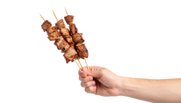 Grilled meat skewer held by hand with juicy cooked pieces on wooden sticks