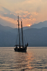 Sunset Over Mountains and Waters of Italian Lake Garda with Old Sailing Ship