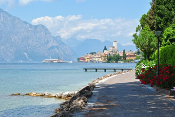 Naklejka premium View of Mountains Lake Garda and Malcesine from Footpath on Sunny Day 