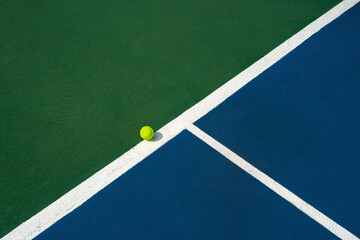 Tennis ball on the white line.