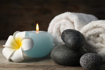 Composition with spa stones on wooden table, closeup