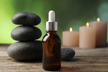Spa stones and cosmetic product on wooden table, closeup