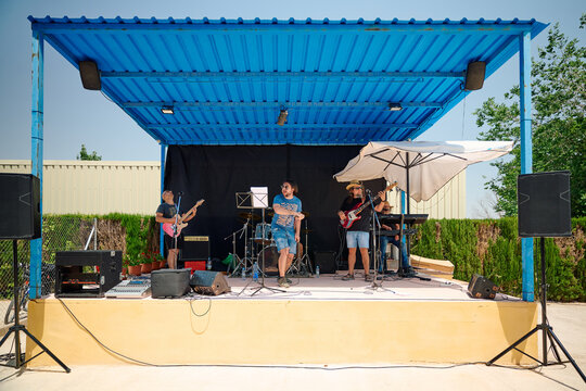 Rock band performs on a summer afternoon at outdoor stage