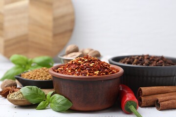 Different aromatic spices on white table, closeup. Space for text