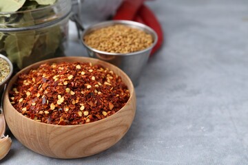 Different aromatic spices on grey table, selective focus. Space for text