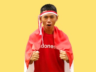 Indonesian young boy in red outfit and red white headband shouted excitedly during Indonesia...