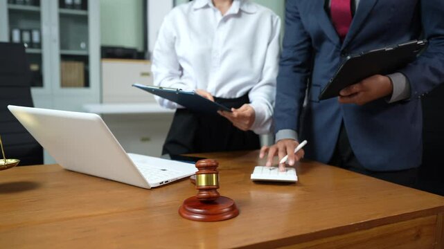 Business people and lawyers discussing contract papers sitting in the table at office, concepts of law, advice, legal services.