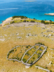 Aerial perspective of the historic dry-stone walls forming a network across the coastal landscape...