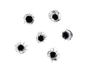 Six impactful bullet holes shatter clear glass, creating a powerful visual of damage and force.