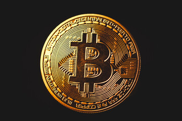 A shiny golden Bitcoin stands out in close-up, symbolizing cryptocurrency, digital finance, blockchain technology, decentralization, investment potential, wealth, futuristic economy, security, and cas