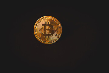 A shiny golden Bitcoin stands out in close-up, symbolizing cryptocurrency, digital finance,...