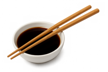 Chopsticks resting on bowl of soy sauce with transparent background