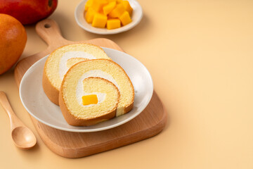 Delicious mango cream Swiss roll cake on plate