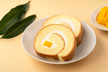 Delicious mango cream Swiss roll cake on plate
