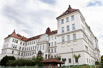 Corner tower and sweeping wings of Brno University of Technology lit by soft midday light, Czech Republic education icon