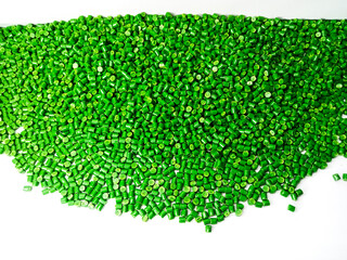 Green polymer granules, blue masterbatch granules, cold cutting material type, isolated on white...