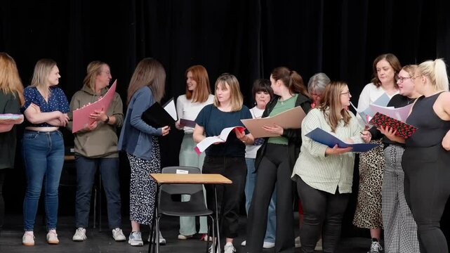 Amateur drama club performers, dialogue script reading, panning left