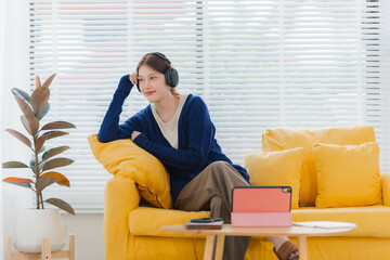 Woman Relaxing at Home with Headphones and Tablet