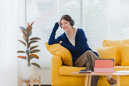Young Woman Relaxing at Home with Headphones