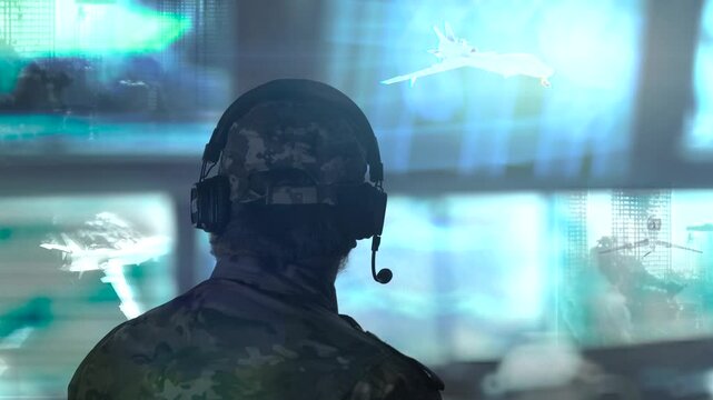 Military drone operator in the army call center with many blue monitors