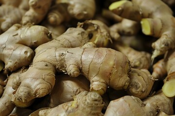 Fototapeta premium Close up of a pile of fresh ginger roots, showcasing their unique shapes and textures