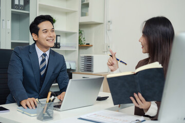 Asian business team working on a project in the office or reviewing and discussing a business project.