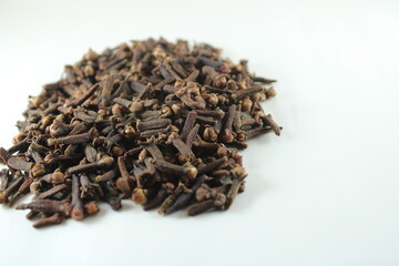 Stack of dried cloves isolated on white background. Aromatic spice used in cooking, baking, and traditional medicine. Ideal for food, herbal, and organic-themed visuals