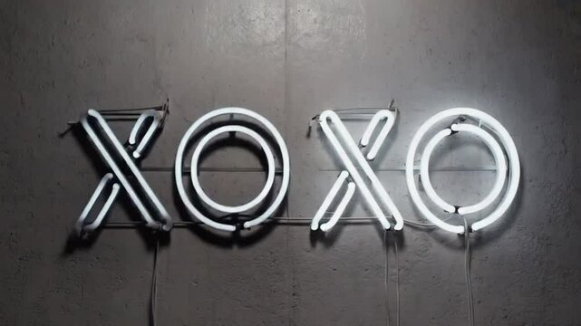 Neon sign with the text XOXO.